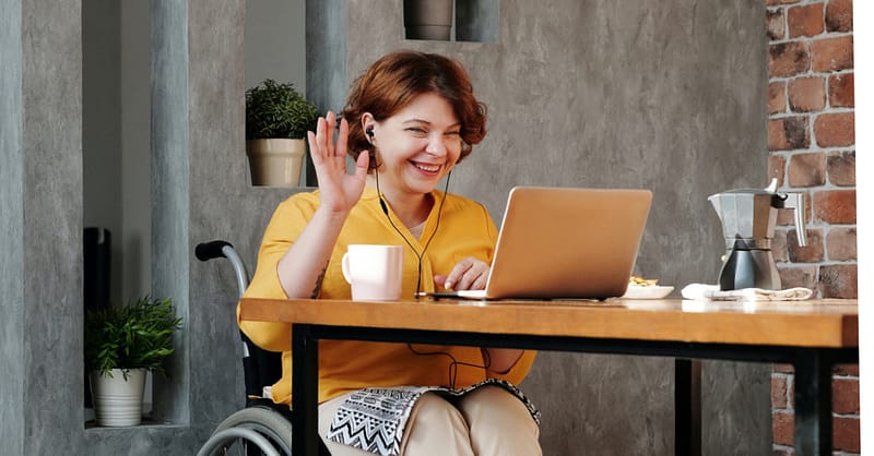 Person working at table with laptop
